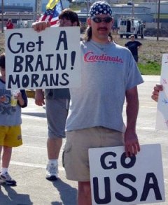 A conservative's misspelt sign: Get a BRAIN! Morans.